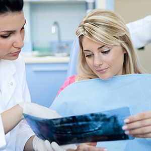 Woman and dentist looking at x-rays