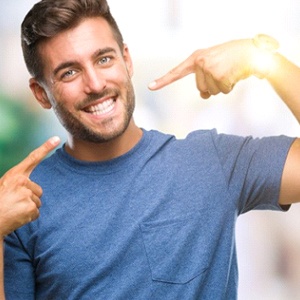 man pointing to his smile