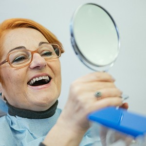 Woman happy with dentures in Jacksonville