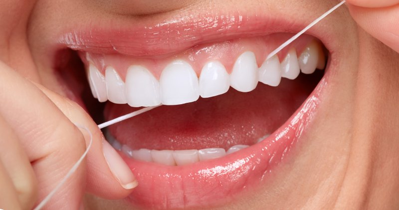 Woman smiling while flossing