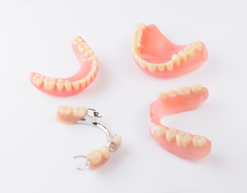 Four sets of dentures lying on a table